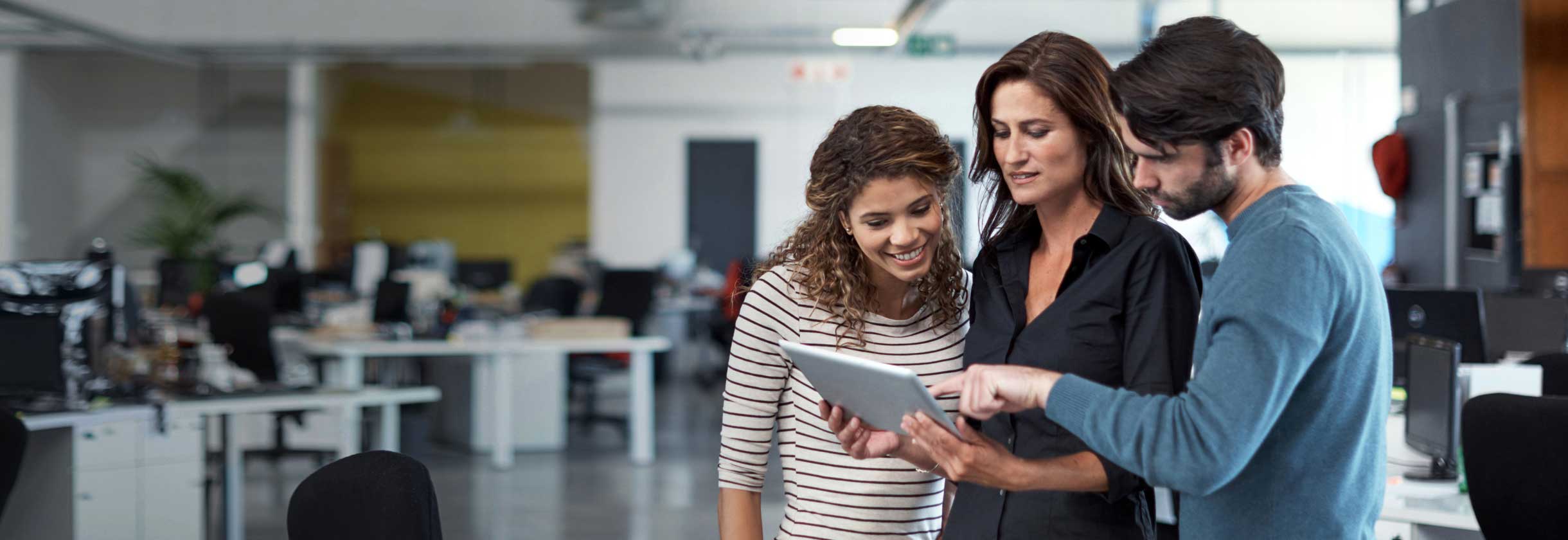 Team members using a tablet 
